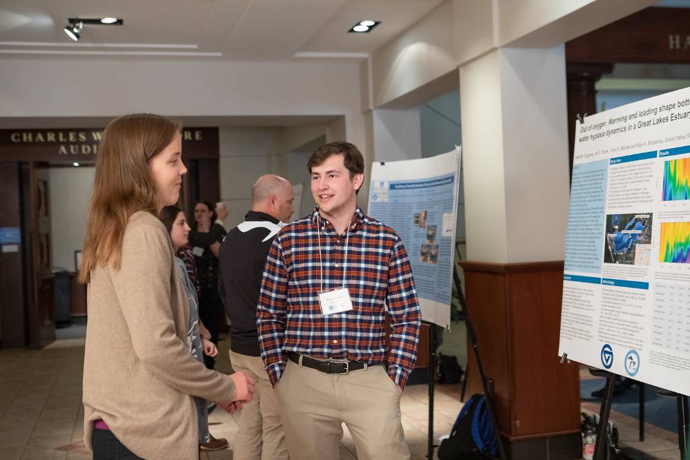 Nate Dugener discussing his poster with Maggie.